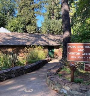 a park entrance and visitor center sign in front of a building