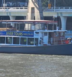 a ferry boat on the water near a bridge
