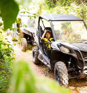 a man is in a jeep on a dirt road