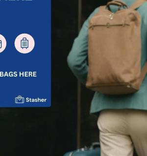 a woman with a backpack and luggage in front of a screen