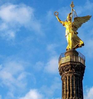 a statue of an angel on top of a pole