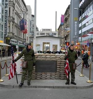 two men in uniform standing next to a monument in a city