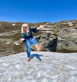 a woman is dancing on a pile of snow