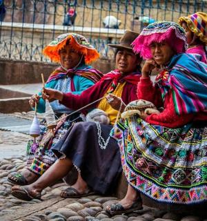 a group of women sitting on the ground
