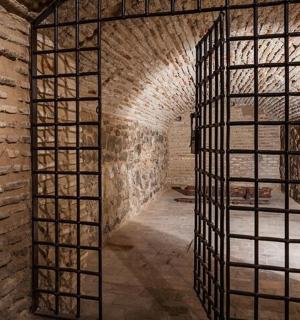 a brick hallway with a brick wall and a window