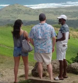 egy három emberből álló csoport áll egy domb tetején