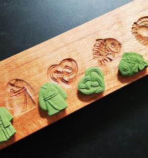 a group of buttons on a wooden cutting board