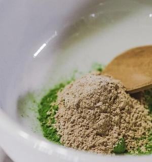 a bowl with a wooden spoon and some spices