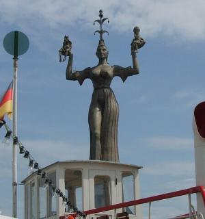 a statue of a woman on top of a building