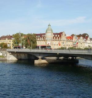 a bridge over a river in front of a city