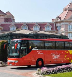 a red bus parked in front of a building