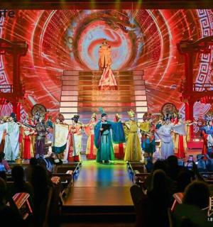 a group of people on a stage in front of a crowd