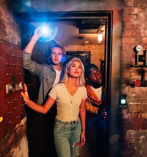 a woman standing in front of a mirror in a room
