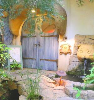 a house with a garden with a pond and a door