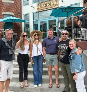 a group of people posing for a picture on some stairs