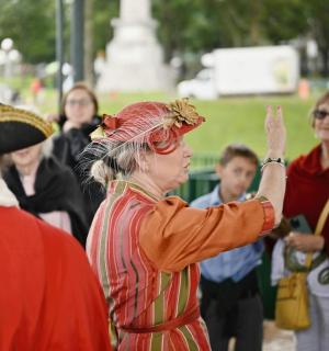 a woman wearing a costume in a crowd of people