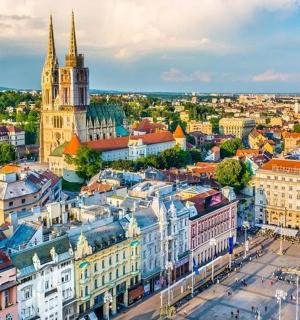 an aerial view of a city with a church