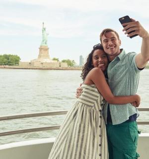 a man and a woman taking a picture on a boat