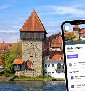 a cell phone in front of a building on the water