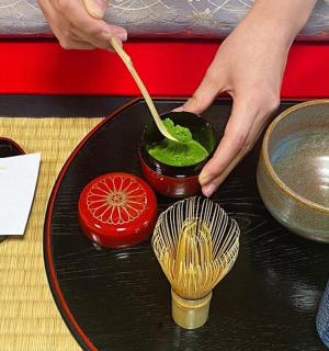 a person stirring a drink in a bowl on a table