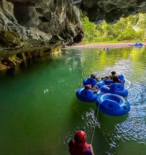a group of people riding on rafts in a river