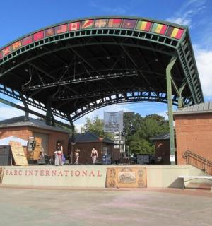 a band is playing under a stage in a building