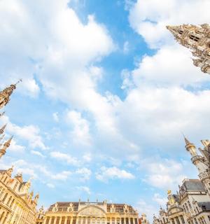 a group of tall buildings with a cloudy sky