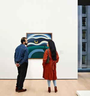 a man and a woman looking at an art exhibit