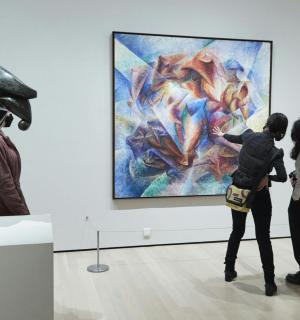 a group of people looking at a painting in a museum