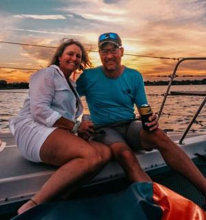 a man and woman sitting on a boat in the water