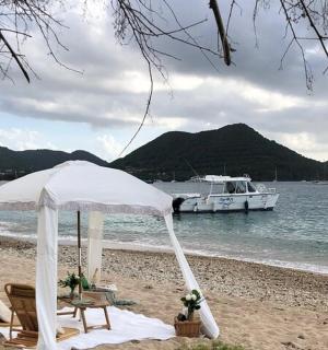 Stan a židle na pláži s lodí