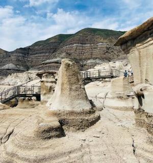 a sand sculpture of a desert with mountains in the background