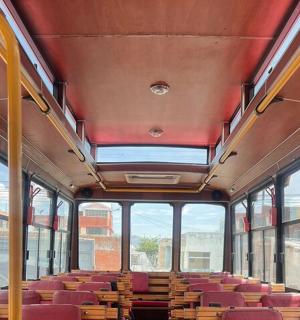 an empty bus with red seats and windows