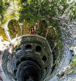 a woman is sitting on top of a tunnel