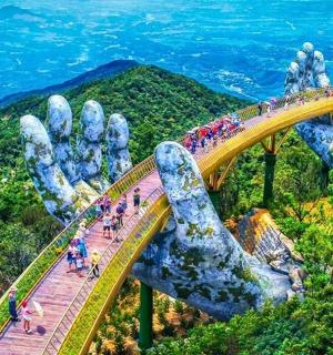 a group of people walking on a bridge in the mountains
