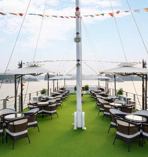 a group of tables and chairs on the deck of a boat