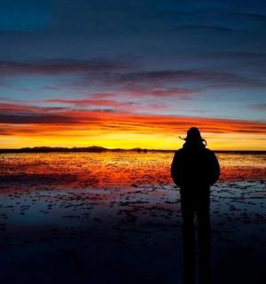 一个人站在海滩上看日落