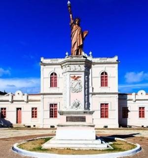 a large building with a statue in front of it