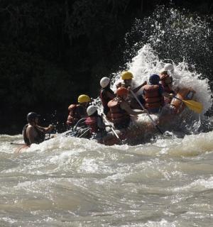 a group of people in a raft in the water
