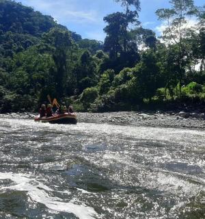 a group of people in a boat on a river