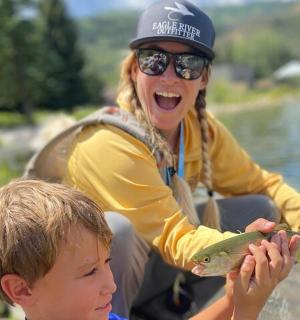 一名妇女和一名男孩拿着一条鱼