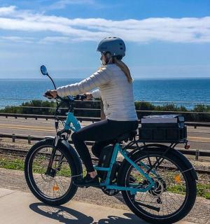 a woman is riding a bike on the road