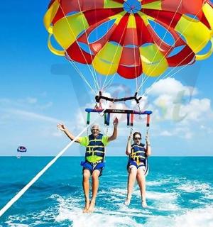 two people are on the water with a parachute