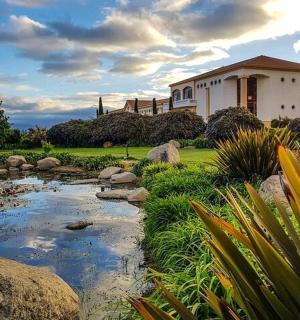a house with a pond in front of a yard