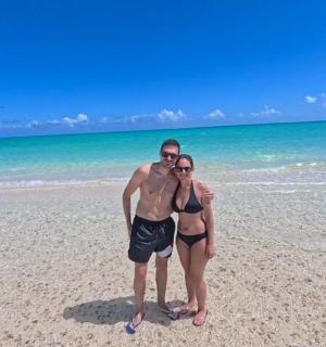 a man and a woman standing on a beach