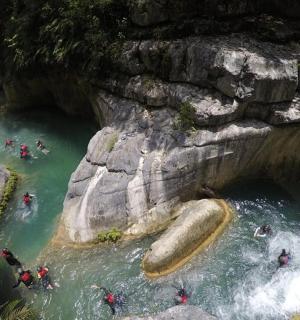 a group of people rafting in a river in a cave