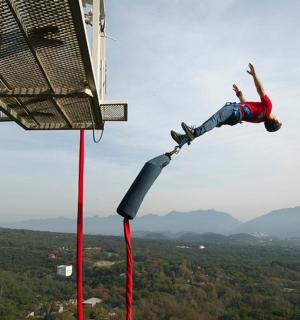 a man is rappelling off of a tower