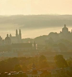 a view of a city in the fog with buildings