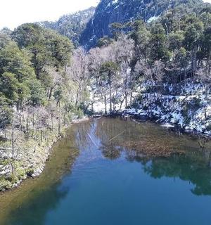 an aerial view of a lake in the mountains