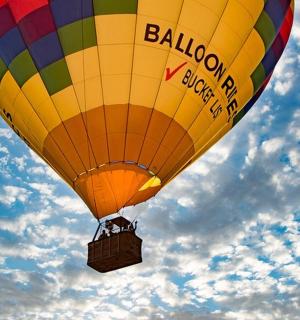 a colorful hot air balloon flying in the sky